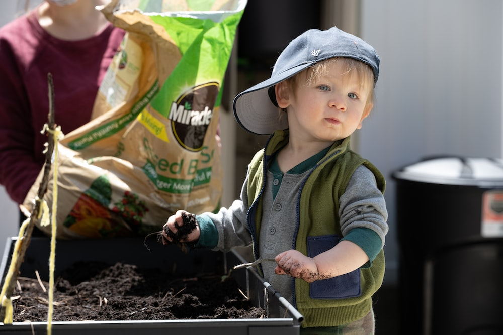 A kid with his hands in the soil