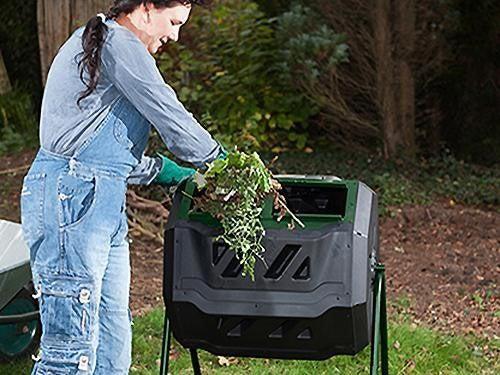 A woman putting organic waste into a composter