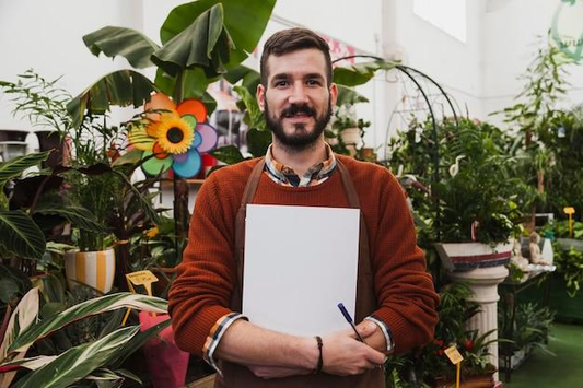 An artist painting inside his greenhouse