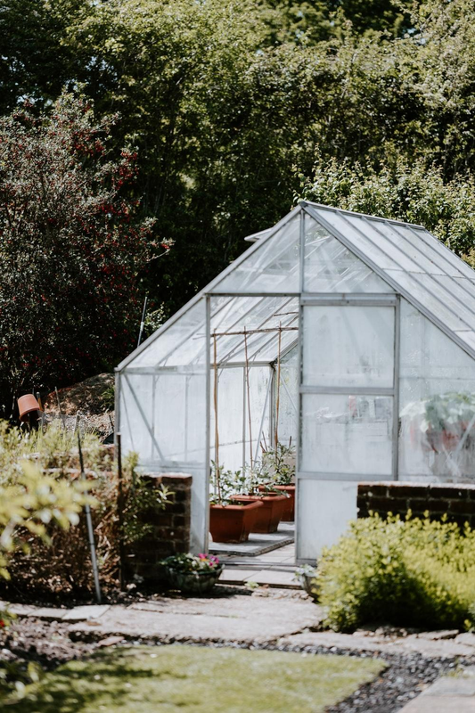 A beautiful greenhouse installed in a residential yard