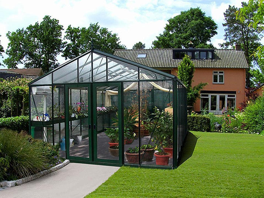 Janssens Royal Victorian VI46 greenhouse with glass walls and organized shelving designed for urban gardening and year-round plant growing