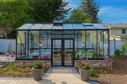 Modern backyard greenhouse furnished as a stylish lounge space with curtains and seating.