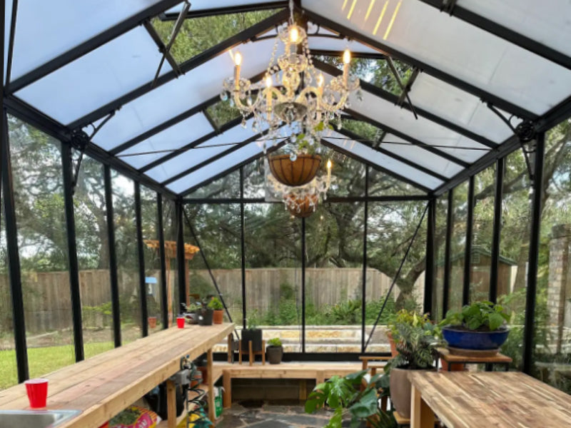 Royal Victorian VI34 greenhouse interior with translucent roof panels, glass walls and wooden potting benches