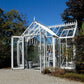 White EOS T-shaped greenhouse in a landscaped garden