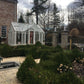 White EOS T-shaped greenhouse in a formal manor garden with clipped hedges