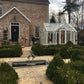 EOS Royal Antique Victorian greenhouse in front of a brick manor house