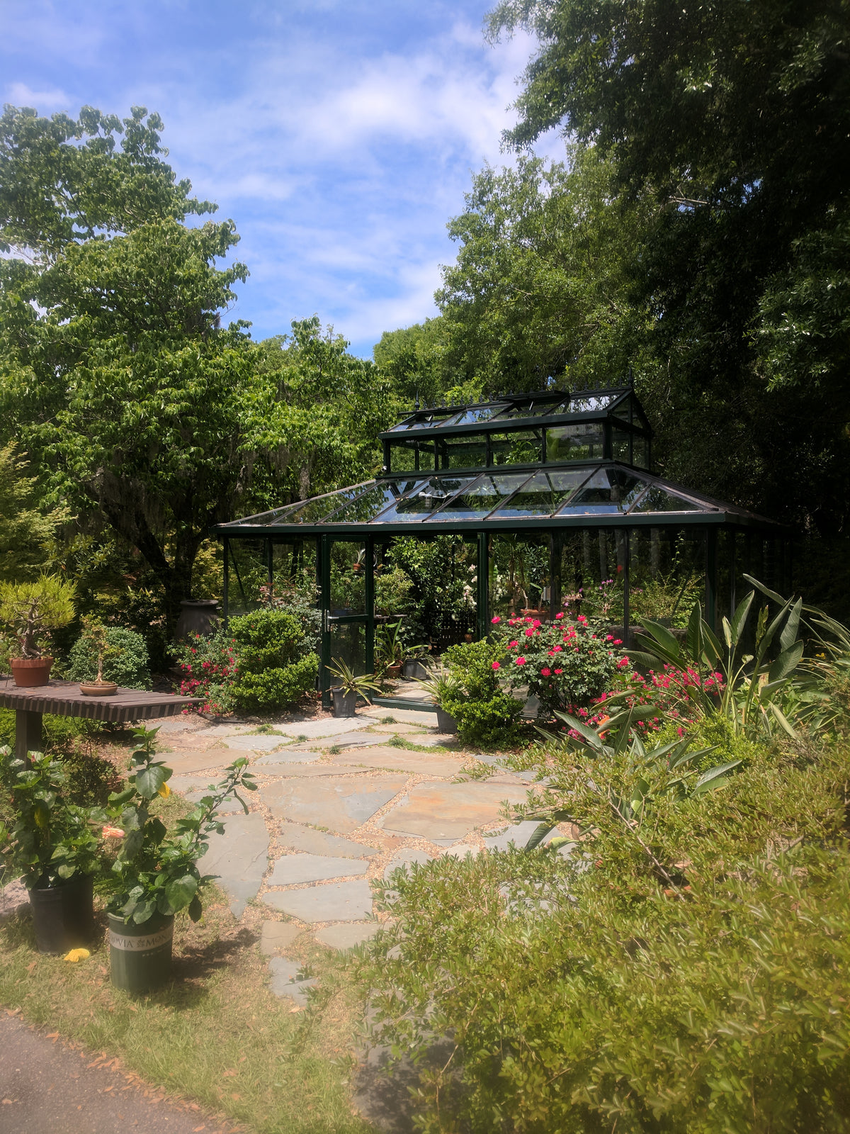 Cathedral Victorian Orangerie surrounded by flowering shrubs