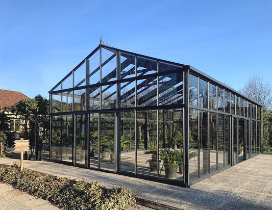 Side view of a black Janssens Gigant glass greenhouse