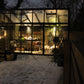 Larger model shown – Exaco Janssens Modern M34 greenhouse lit up at night