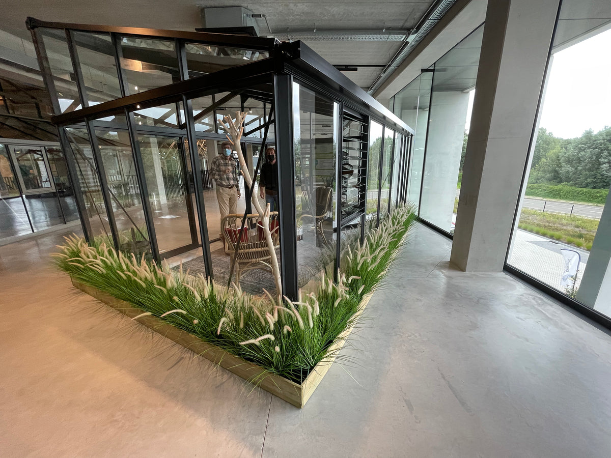 Rear view of a Janssens Modern greenhouse in a showroom (10x15 M34 shown)