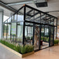 Smaller model shown – Exaco Janssens Modern M34 greenhouse in a showroom
