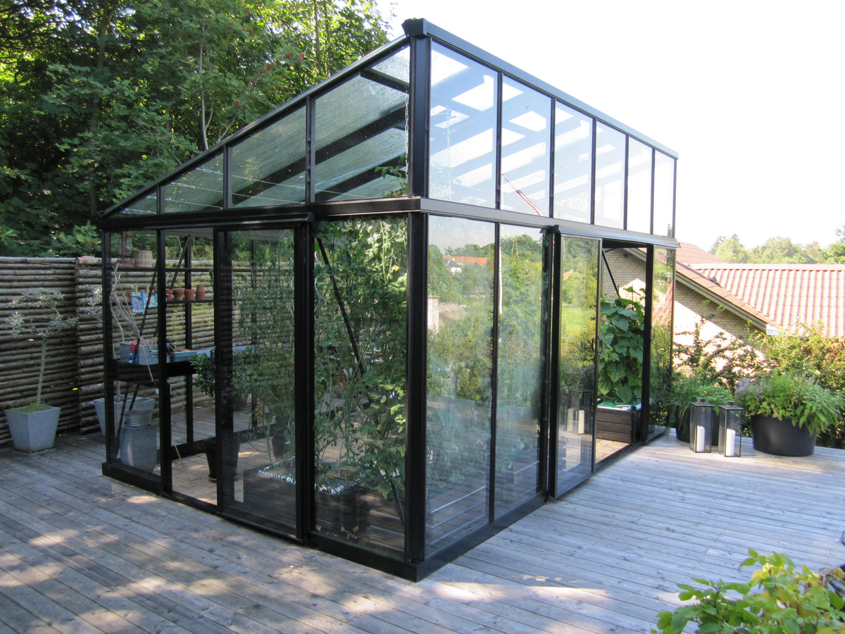 Janssens Modern greenhouse with sliding doors on a patio (10x15 M34 shown)