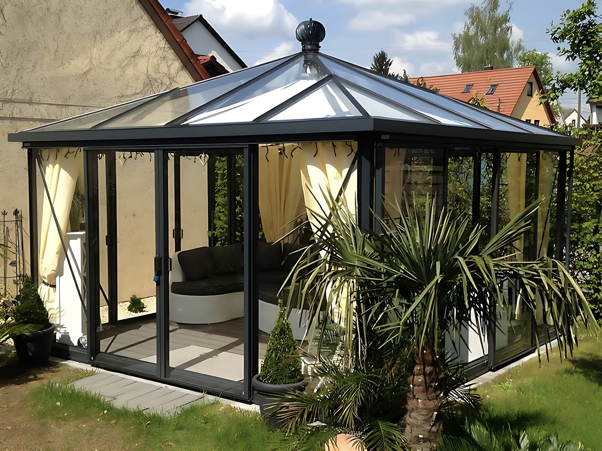 Janssens Pyramid glass greenhouse used as a garden room with curtains and lounge seating