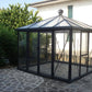 Janssens Pyramid glass greenhouse on a stone patio with roof vent and double sliding doors