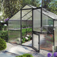 Hoklartherm Nelke 4 Pro greenhouse with anthracite frame and open Dutch barn door in a garden with purple hydrangeas