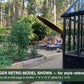 Garden view from the door of a black Janssens Retro Victorian greenhouse – larger Retro model shown for style reference; the Retro 23 is 7'9" x 10'2"