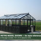 Black Janssens Retro Victorian greenhouse on a gravel base – larger Retro model shown for style reference; the Retro 23 is 7'9" x 10'2"