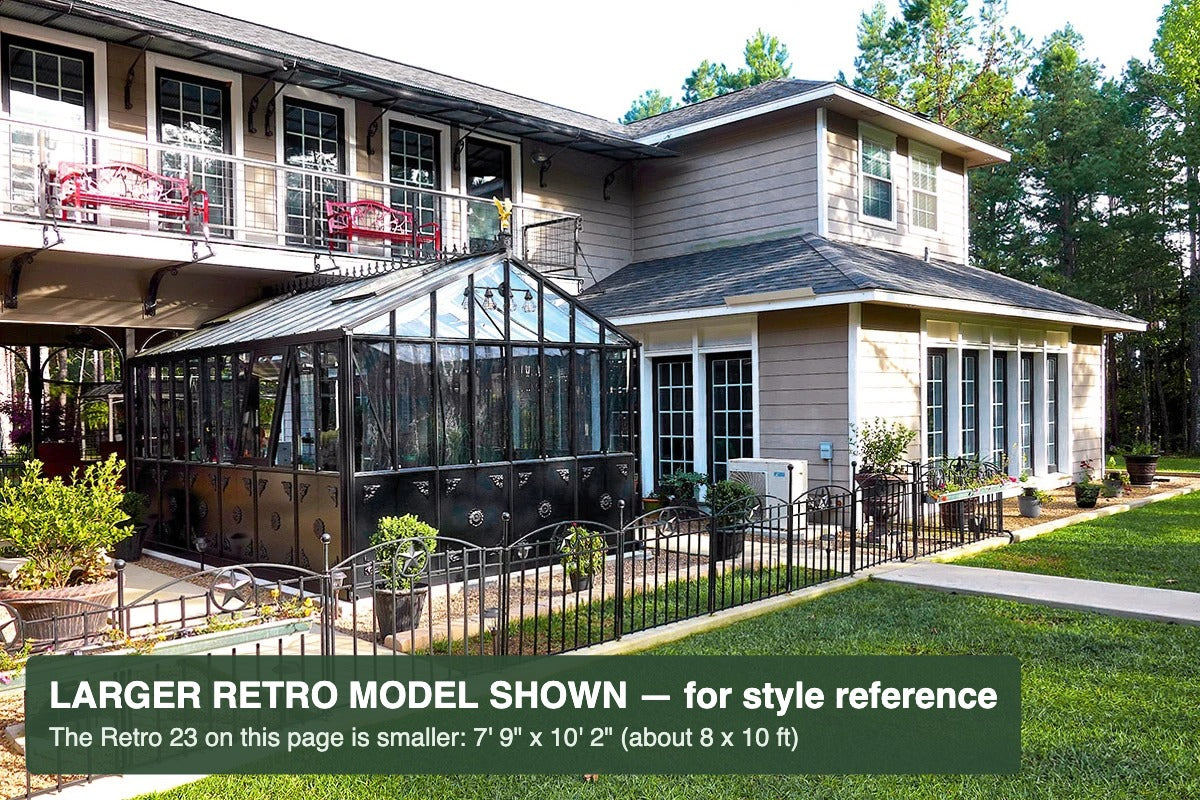 Black Janssens Retro Victorian greenhouse beside a home – larger Retro model shown for style reference; the Retro 23 is 7'9" x 10'2"