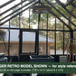Inside a black Janssens Retro Victorian greenhouse – larger Retro model shown for style reference; the Retro 23 is 7'9" x 10'2"