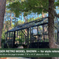 Black Janssens Retro Victorian greenhouse among pine trees – larger Retro model shown for style reference; the Retro 23 is 7'9" x 10'2"