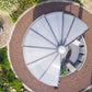 Aerial view of the Rondo pavilion showing its round roof and circular base in a landscaped garden