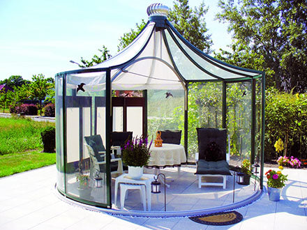 Dark-frame Rondo pavilion with pyramid roof on a pale stone terrace