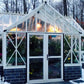 White Royal Antique Orangerie lit up at night in winter snow