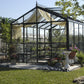 Front view of the Royal Victorian VI34 glass greenhouse with interior curtains
