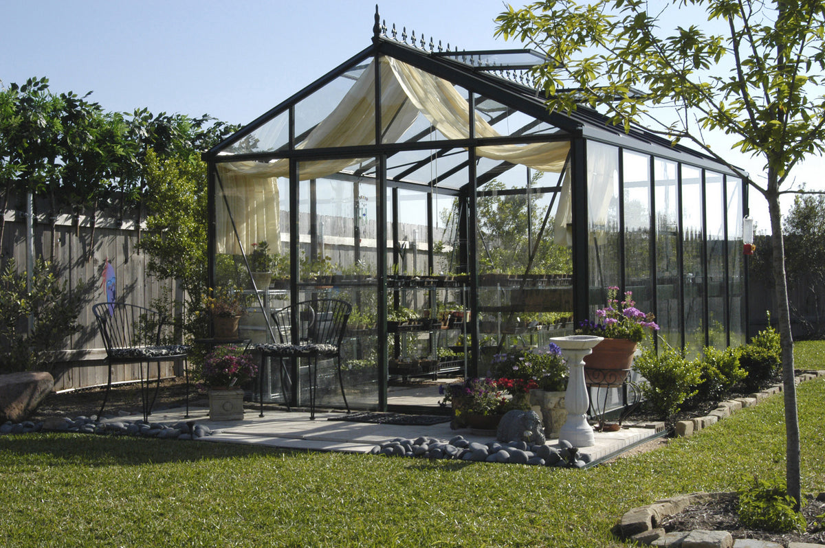 Front view of the Royal Victorian VI34 glass greenhouse with interior curtains