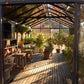 Inside a Royal Victorian VI36 greenhouse: seating area in sunlight