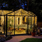 Janssens T-Shaped Royal Victorian Orangerie lit up at night on a patio