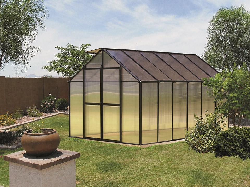 Riverstone MONT 8x12 greenhouse with a black frame in a landscaped backyard
