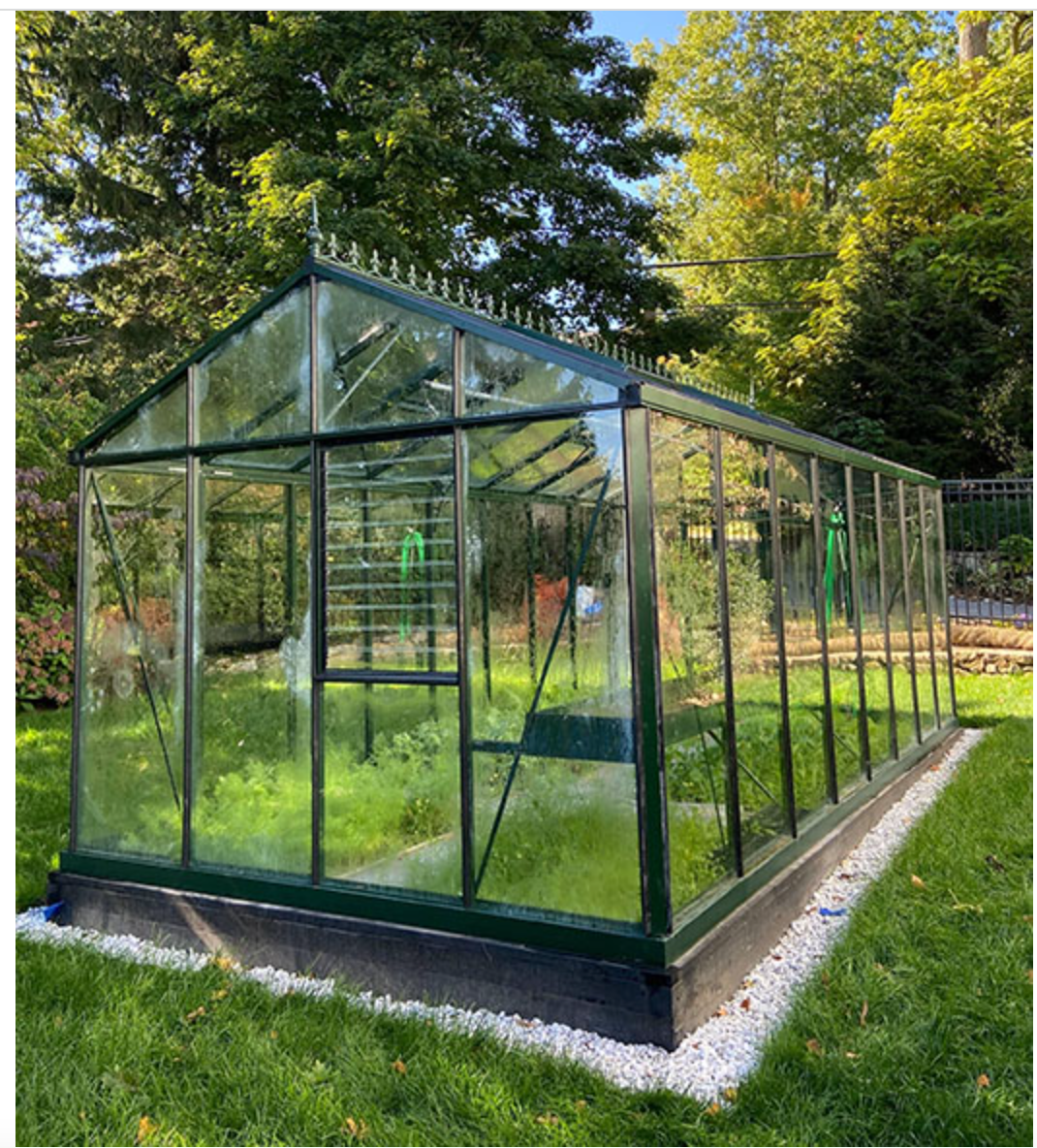 Side view of the Royal Victorian VI36 glass greenhouse on a lawn